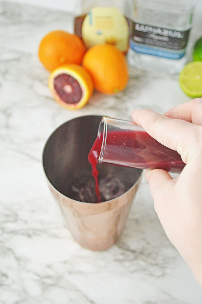 Blood Orange juice pouring into a cocktail shaker