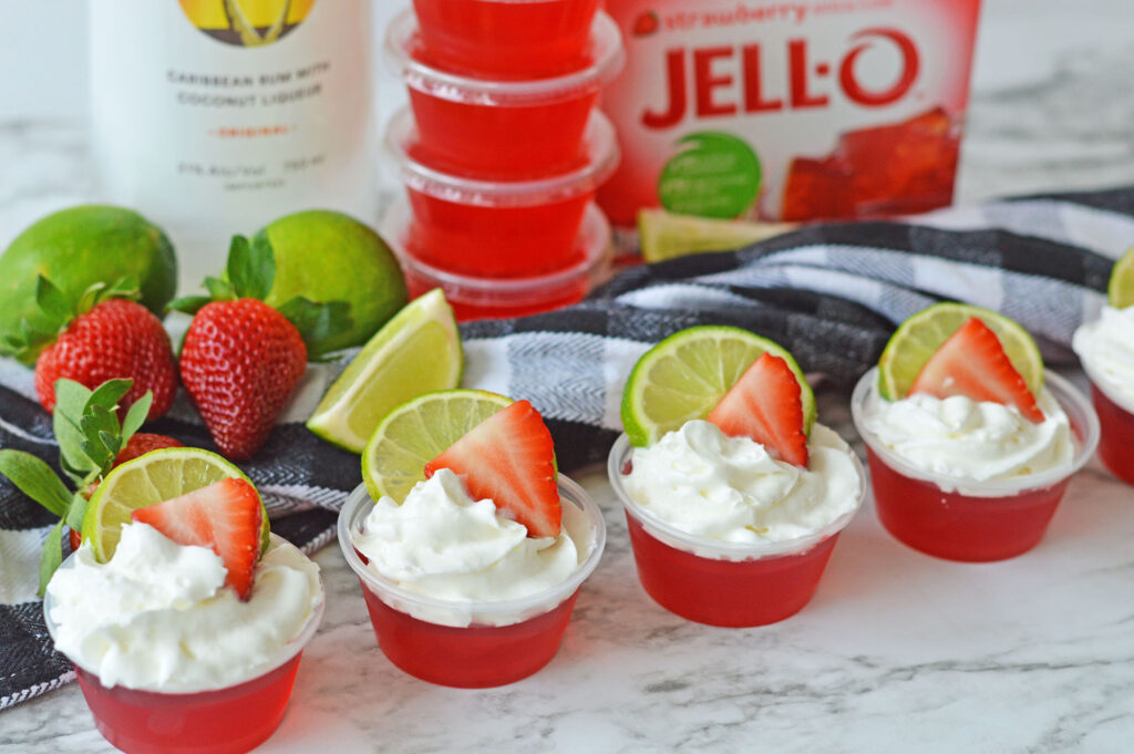 Strawberry Daiquiri Jello Shots lined up on a table