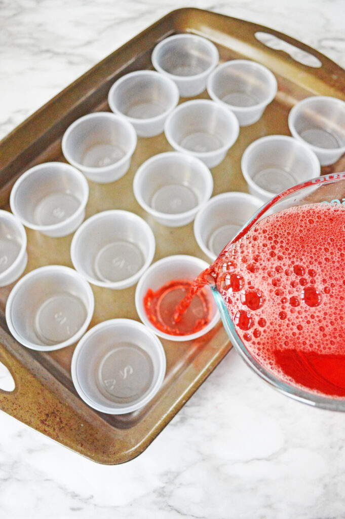 pouring jello into plastic cups